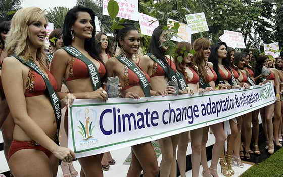 Участницы конкурса "Мисс Земля 2009" позируют в купальниках со своими лозунгами в защиту окружающей среды
